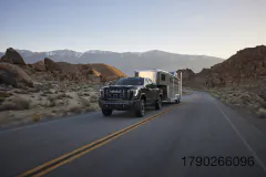 A 2027 GMC Sierra HD Denali Ultimate towing a trailer. Preproduction model shown. Actual production model may vary