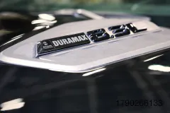 Close up shot of the badging for the new 8.3L Duramax Turbo-Diesel V8 on the hood of a 2027 Chevrolet Silverado HD.